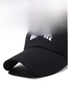 Detail of ENCHANTE embroidery and long curved brim on a black cotton baseball cap