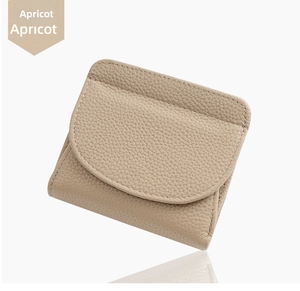 Detail of apricot pebbled leather mini wallet with precise white stitching and envelope flap