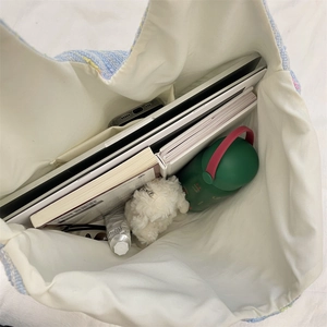 Top view of large tweed tote bag interior showing capacity for laptop and books