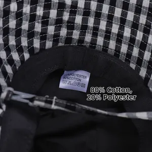 Detail of checkered bucket hat inner lining with material care label and black sweatband