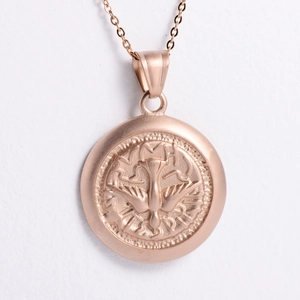Detailed close-up of rose gold peace dove coin pendant with delicate cross chain