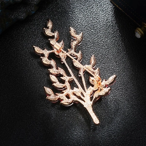 Rose gold wheat spike brooch with red crystals and S925 silver stamp on dark background