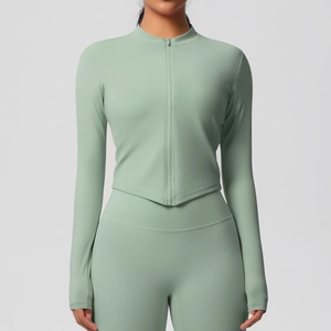 Détail de la veste de sport ajustée vert menthe avec passe-pouces et ourlet en V