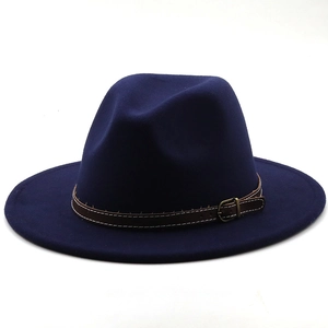 Detail of navy blue felt fedora hat featuring a brown leather decorative band with buckle