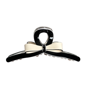 Elegant black and white acetate bow hair claw clip for bun hairstyles with glossy finish