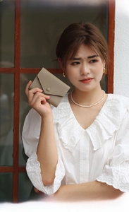 Detail of khaki litchi grain leather card holder with envelope flap and snap button