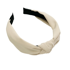 Minimalist beige fabric knotted wide headband with a trendy cross knot design for women