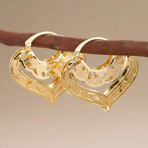 Elegant gold heart hollow earrings with vintage vine pattern and classic hoop closure