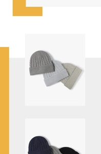 Detailed view of stacked thick ribbed knit beanies in various classic neutral colors