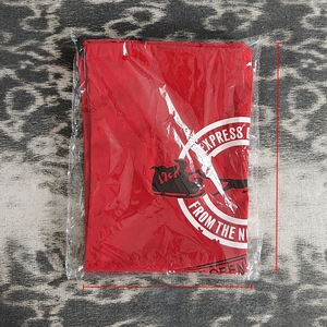 Detail of red Christmas canvas drawstring bag with Santa sleigh print in packaging