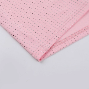 Close-up of pink knitted fabric with silver micro-dots and detailed stitching seams