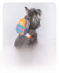 Detail of color-block canvas dog harness featuring a detachable mini backpack and Velcro