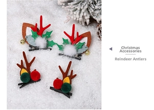 Detailed view of handmade Christmas reindeer antler hair clips with colorful pom poms