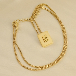 Double-layered 18K gold plated stainless steel necklace featuring a square letter M pendant