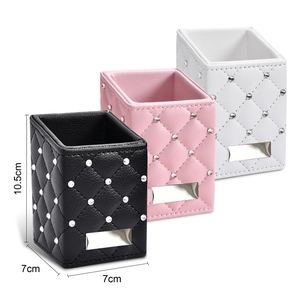 Diamond-quilted leather makeup brush holders in black, pink, and white with crystal accents