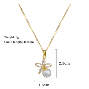 Detail view of pearl butterfly pendant necklace showing dimensions and gold finish
