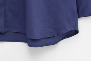 Detail shot of navy blue casual shirt featuring high-quality double-stitched hem and fabric