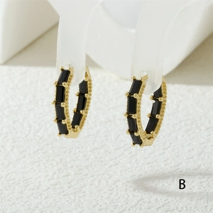 Macro view of 18K gold plated hoop earrings with black rectangular baguette zircons