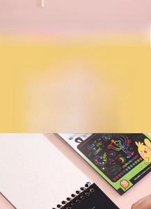 Detail of 10-sheet scratch art notebook with bamboo pen showing colorful creative patterns
