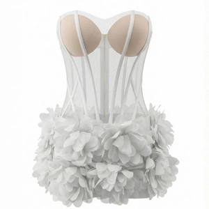Detail of white mesh bustier dress with 3D fabric petals and sheer corset structure