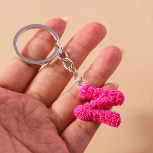 Detail of letter Z keychain featuring pink resin roses with silver metal ring and chain