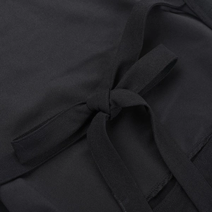 Close-up of a black mesh dress showing a back lace-up bow tie and fine stitching