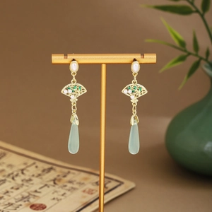 Detail of fan-shaped long tassel earrings with green bamboo leaves and pearls