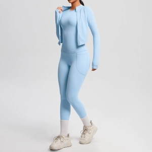 Detail of sky blue yoga set featuring zipper jacket and high-waist leggings with pockets