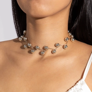 Close-up of a silver CCB beaded necklace with a unique zigzag pattern on a model