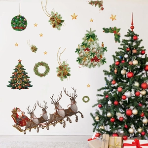 Detailed view of Santa and reindeer Christmas wall stickers applied to a white wall surface