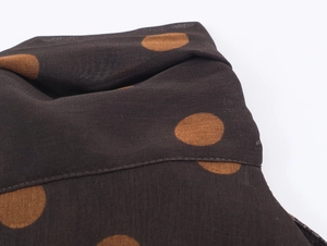 Macro shot of polka dot georgette fabric with precision stitching on a halter top