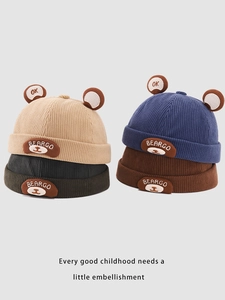 Detail of corduroy kids beanies with cute bear ears in beige, black, blue, and coffee colors