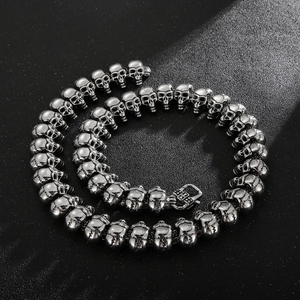 Close-up of hip hop skull links on a polished stainless steel bracelet for men