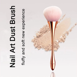 Elegant rose gold nail art dust brush with soft pink gradient bristles on powder