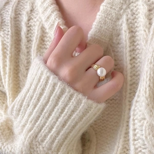Elegant 925 sterling silver gold-plated ring with a large white pearl on model's finger