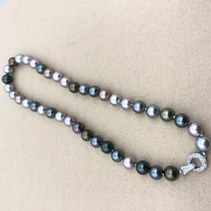 Detailed macro view of multicolor Tahitian pearl necklace with a diamond-encrusted clasp