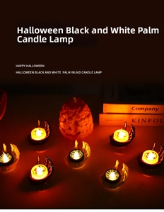 Detail of Halloween LED candles with bone hand bases and spider web patterns for spooky decor