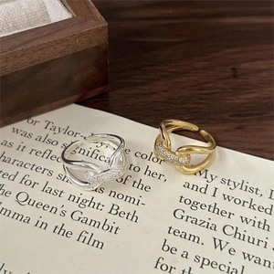 Close-up of 925 sterling silver criss-cross rings with sparkling pavé cubic zirconia