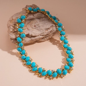 Detail view of double-layer vintage necklace with green resin stones on natural rock base