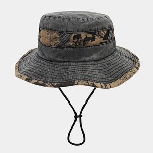 Detail of washed denim bucket hat with newspaper print strap and adjustable drawstring