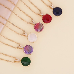 Macro shot of colorful faceted glass pendants on golden twisted chains in various hues