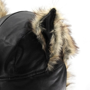 Detailed macro view of black faux leather cat ears with fluffy faux fur on a trapper hat