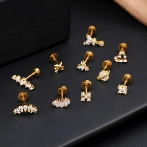 Goldene 16G Edelstahlohrringe mit Schmetterling, Herz und Zirkonia auf dunklem Grund