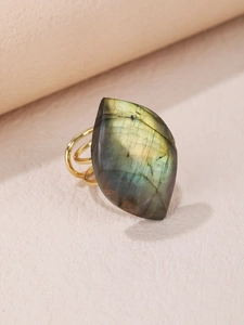 Macro shot of gold multi-layer ring with natural iridescent blue-green labradorite stone