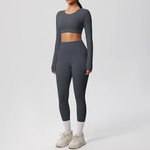 Close-up of charcoal grey high-waist yoga pants and long sleeve crop top fitness set