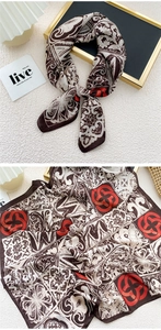 Detail of vintage red and brown silk scarf with geometric patterns and baroque motifs