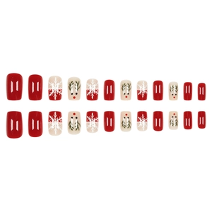 Christmas press-on nails featuring red and white snowflakes and cute reindeer designs