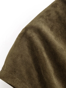 Detail of dark olive green faux suede fabric showing soft texture and fine fuzzy surface