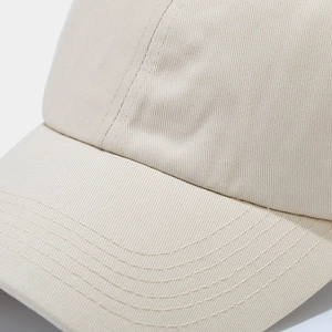 Detailed close-up of light beige cotton baseball cap brim with durable reinforced stitching