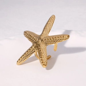 Gold starfish ring made of stainless steel with a textured finish and open band design